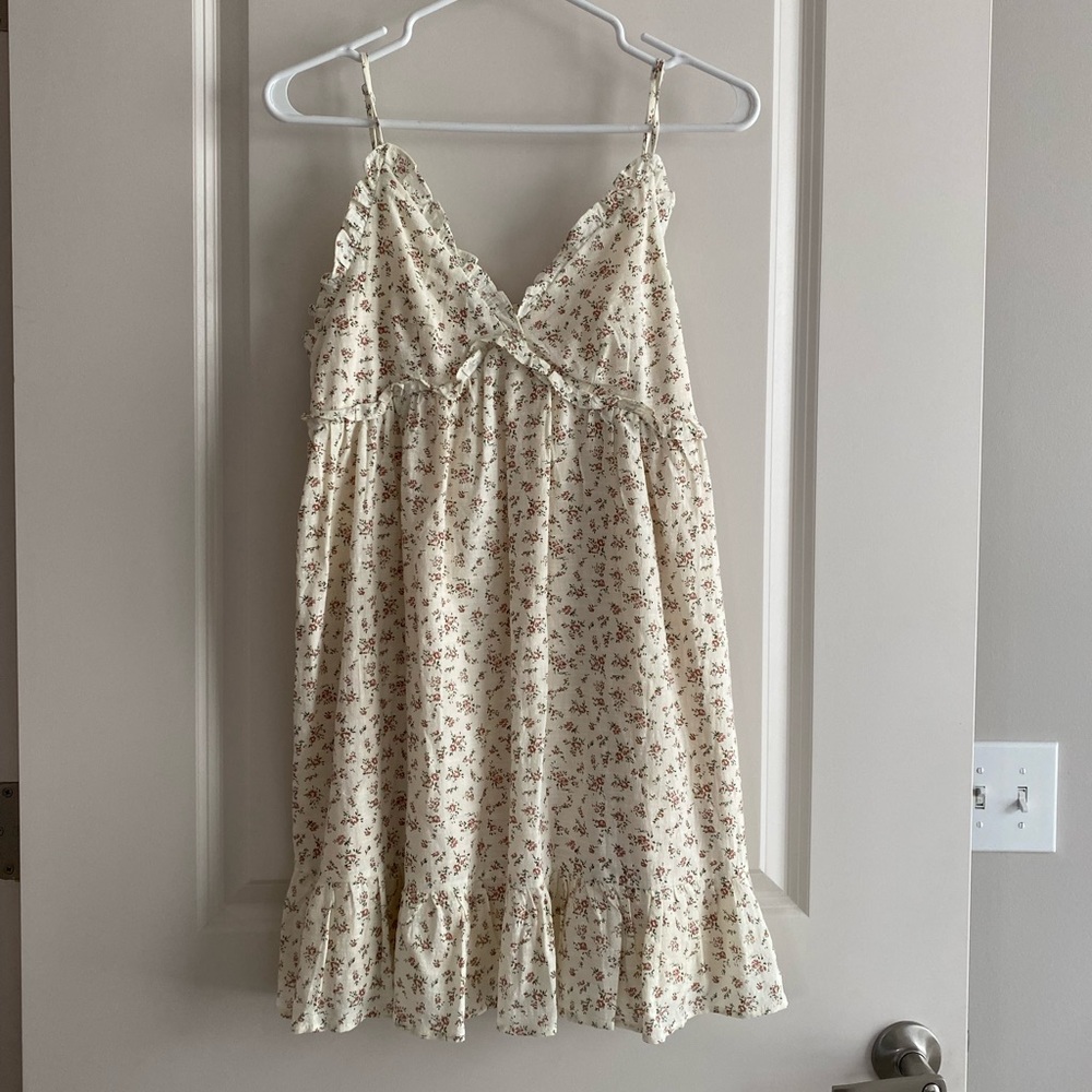 Cream colored ruffle sundress with floral pattern
